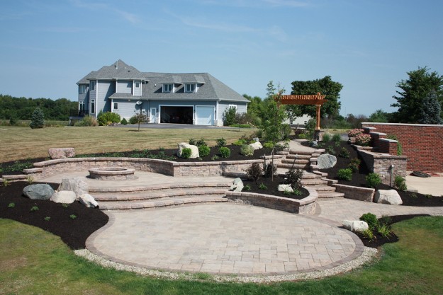 Multiple levels outdoor stone patio with fireplace