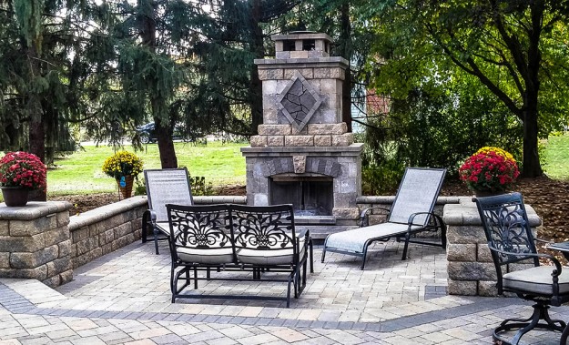 Outdoor living space with Belgard stone fireplace