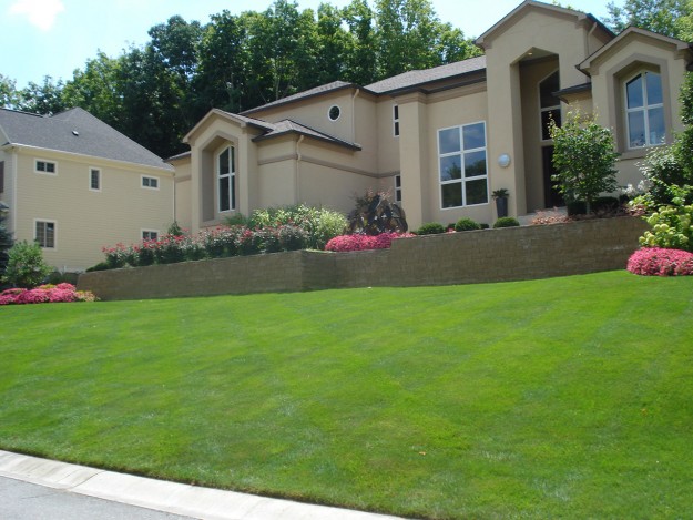 Residential curb appeal with brick wall landscaping