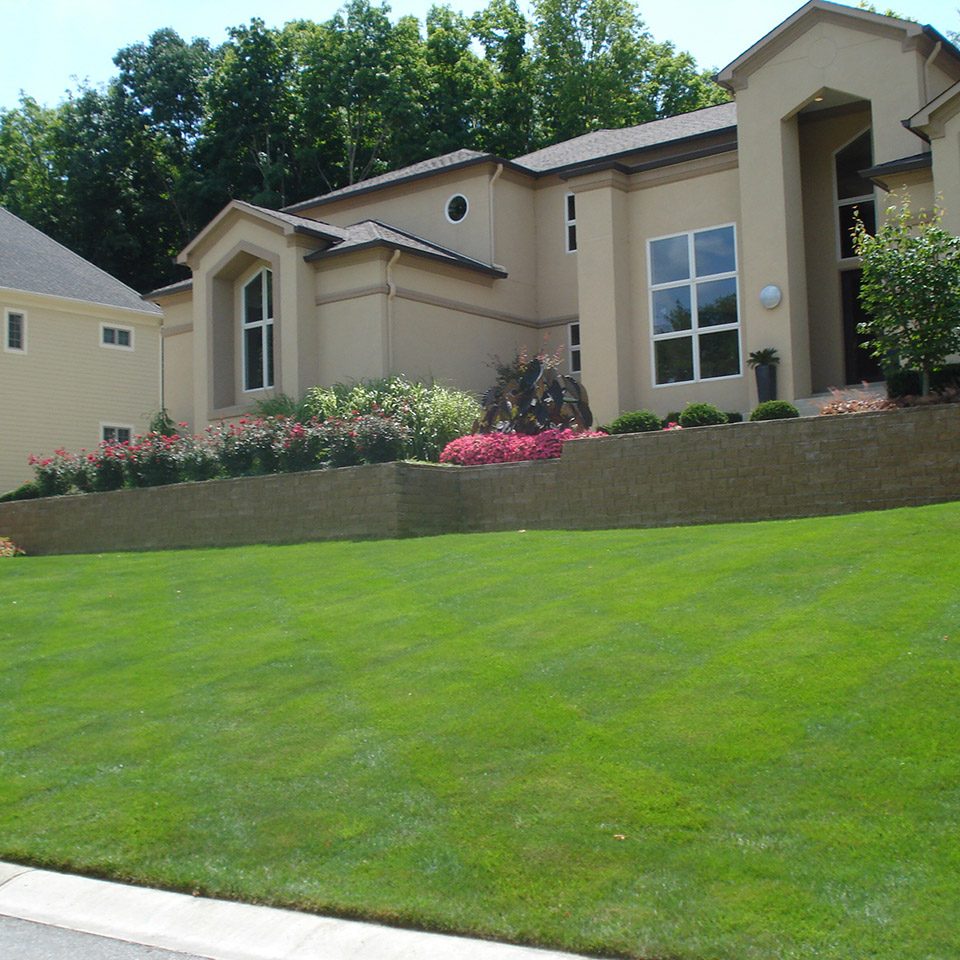 Residential curb appeal with brick wall landscaping
