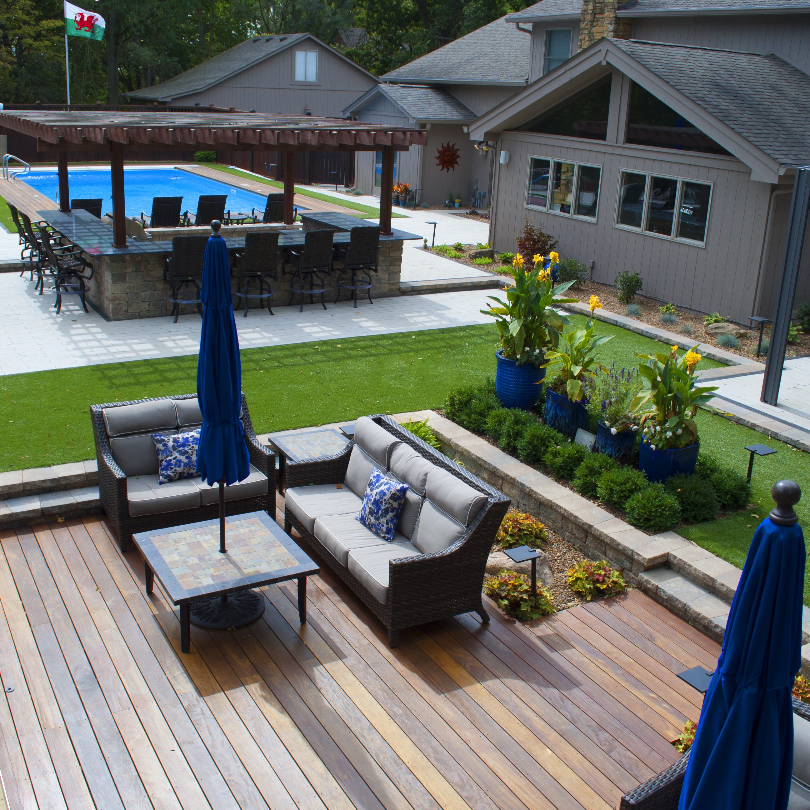 Outdoor living space with patio, kitchen, and pool
